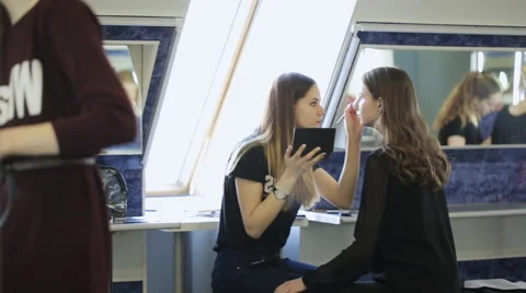 Young girls prepare for photoshoot in dressing room in day time Stock Footage