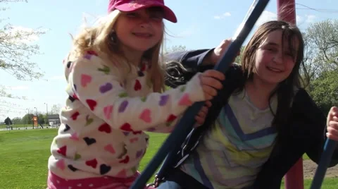Young girls on a swing Stock Footage 54399865