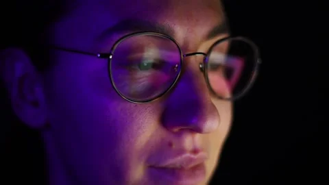 Young with glasses looking at the screen, reflection in the lenses of glasses Stock Footage 302809016
