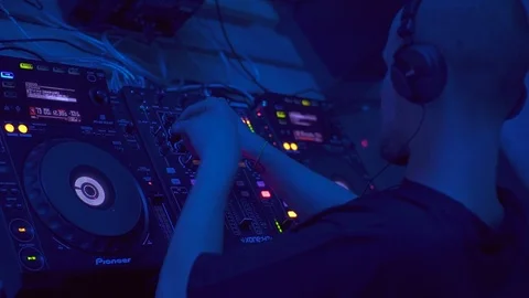 Young good-looking Caucasian man in black T-shirt standing near DJ booth and Stock Footage 95928655