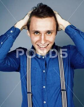Young goofy man with pimples pointing in studio Stock Photos