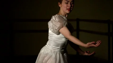 Young graceful ballerina dancing elements of classical ballet Stock Footage 148233117