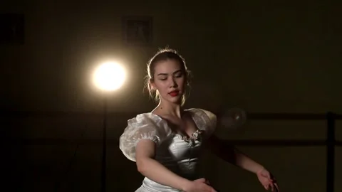 Young graceful ballerina dancing elements of classical ballet Video stock 148233183