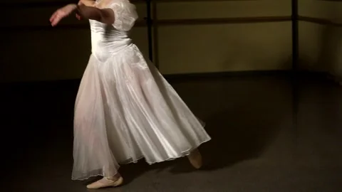 Young graceful ballerina dancing elements of classical ballet Stock Footage 148233331