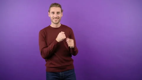Young graceful guy dynamically dancing on isolated purple background Stock Footage 148833294