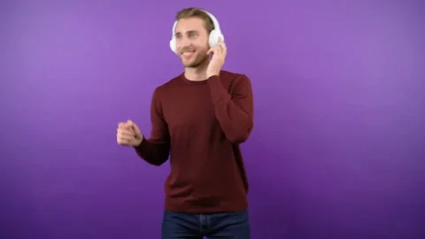 Young graceful guy dynamically dancing on isolated purple background in big Stock Footage 149040195