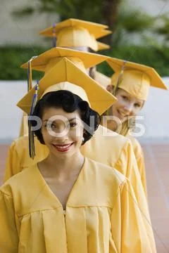 Young Graduates Standing In A Row Stock Photos