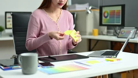 Young graphic designer using pen tablet and laptop at creative desk in mode.. Stock Footage 312436992