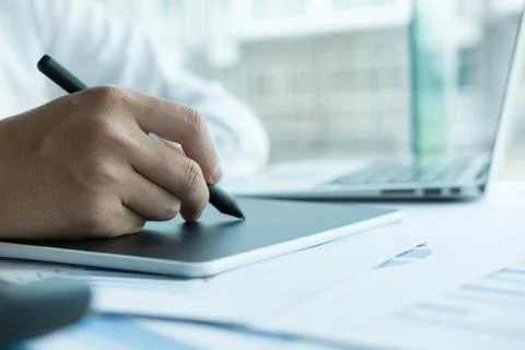 Young graphic designer working with computer. creative man using digital tabl Foto stock