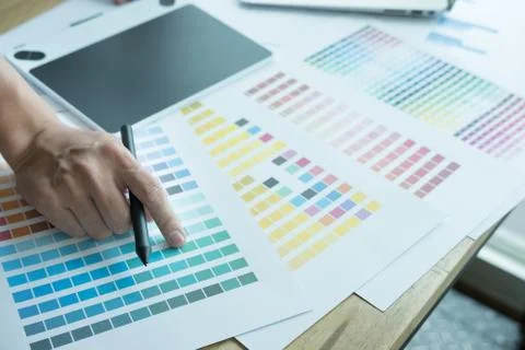 Young graphic designer working with computer and color swatch. creative man u Stock Photos