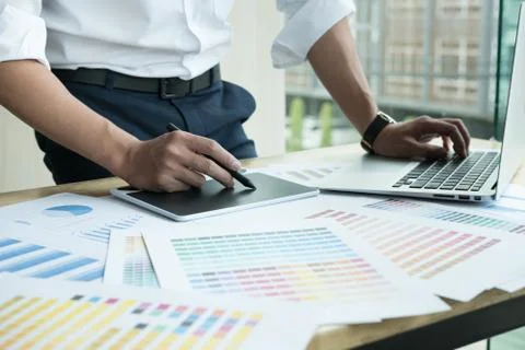 Young graphic designer working with computer and color swatch. creative man u Stock Photos