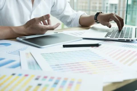 Young graphic designer working with computer, color swatch. creative man usin Stock Photos