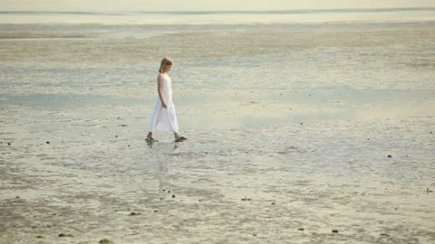 Young gril walking on a beach Stock Footage 132700110