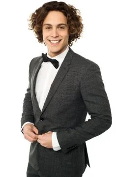 Young groom buttoning up his blazer Stock Photos