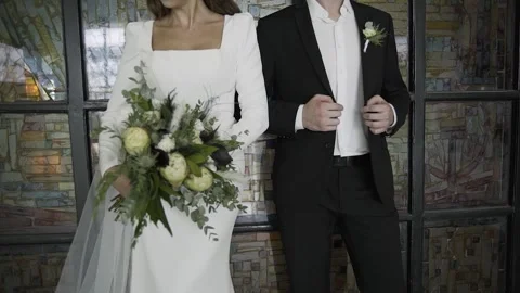 Young grooms bride standing near a beautiful vintage wall In wedding clothes Stock Footage 306145053