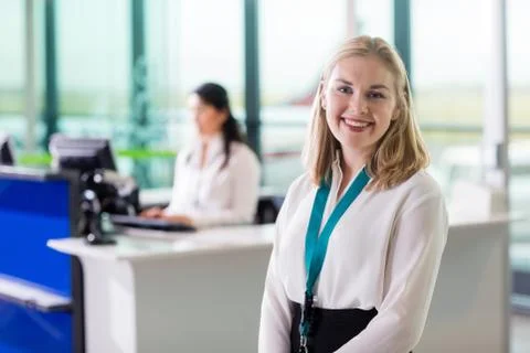 Young Ground Staff Smiling While Colleague Working At Airport Re Stock Photos
