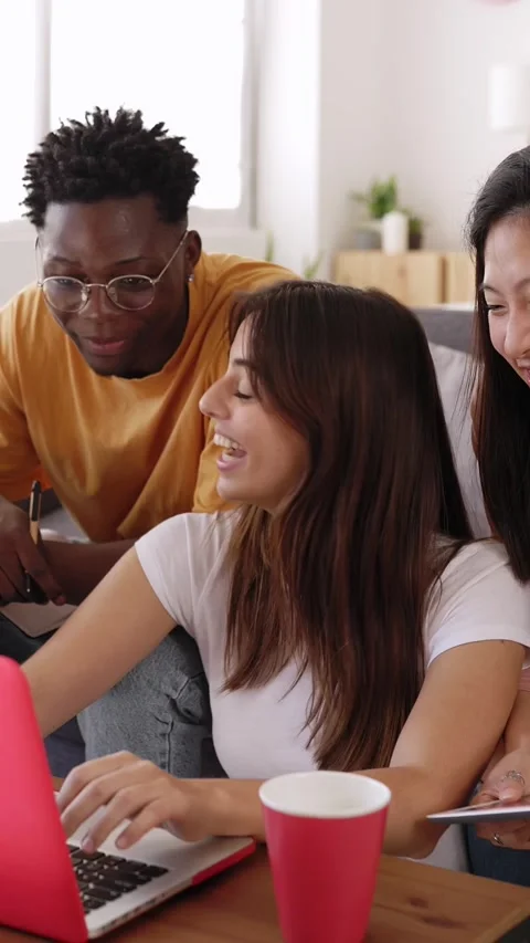 Young group of diverse students studying together using laptop at home Stock Footage 266747521