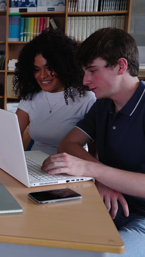 Young group of diverse students studying together using laptop at home Stock Footage 312198149