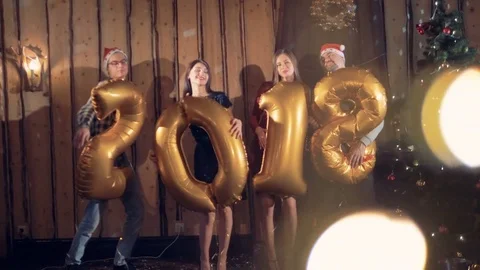 Young group of friends with 2018 figures balloons looking into camera. New year Stock Footage 82162041
