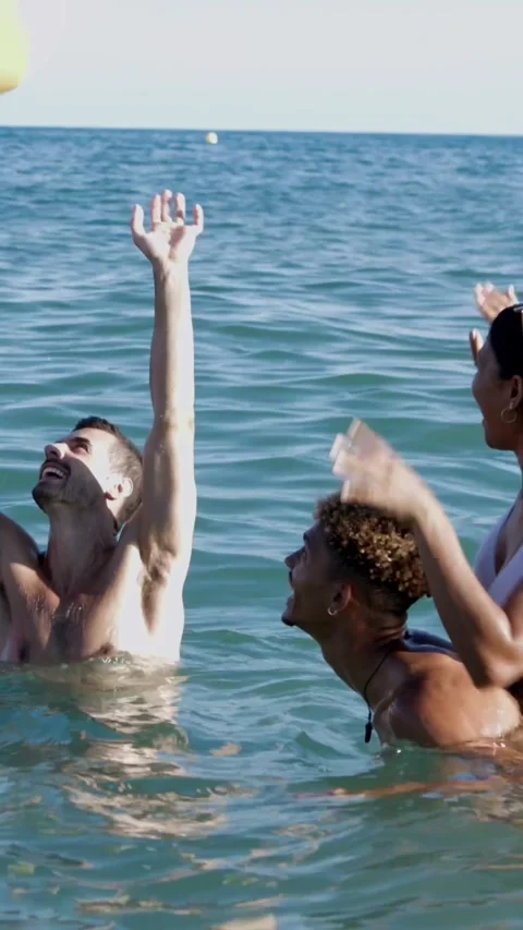 Young group of friends having fun playing with beach ball in summer Stock Footage 277467965