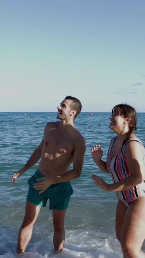 Young group of friends having fun playing with beach ball in summer Stock Footage 277468021