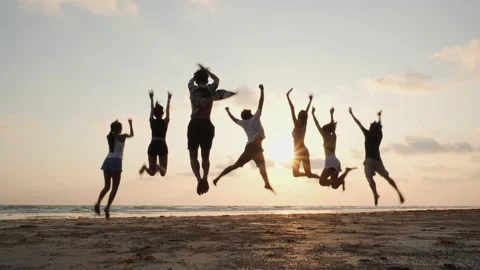 Young group happy jumping on the beach. Stock Footage 177975494
