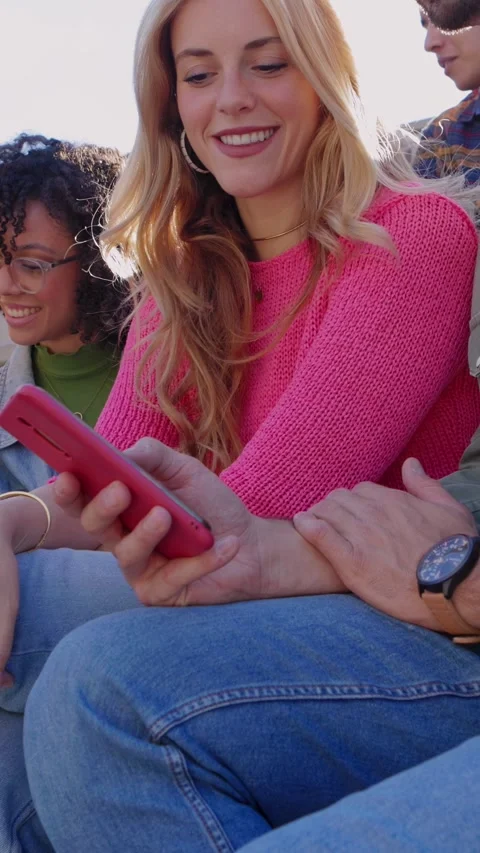 Young group of happy students using mobile phone together outdoors Stock Footage 312262132