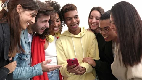Young group of people having fun watching social media content on mobile phone Stock Footage 218360899