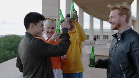 Young group of people having fun drinking beer together outdoors. Stock Footage 250421939