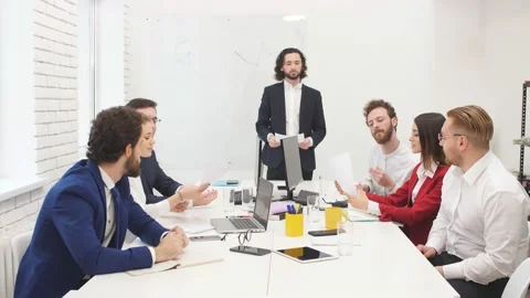 Young group of programmers is working on new project. Group of colleagues works Stock Footage 125553338