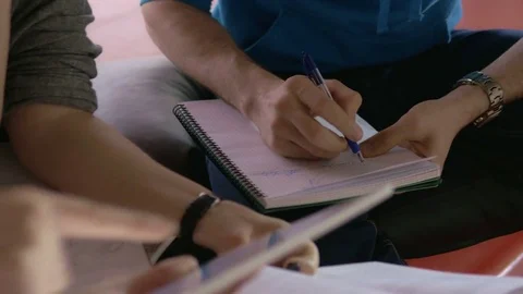 Young group of students with a tablet and notebooks working together Video stock 75555514