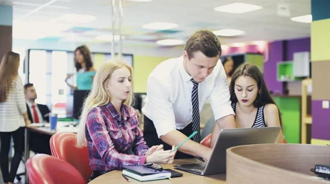 Young group working together as team in busy modern office Stock Footage 65996295
