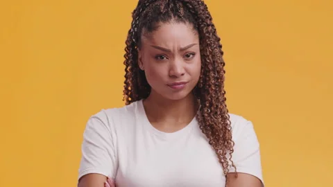 Young grumpy offended african american woman looking at camera with folded arms Stock Footage 149898906