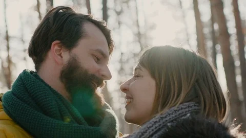 A young guy and a girl dressed in warm winter clothes, enjoy the presence of Stock Footage 99952995