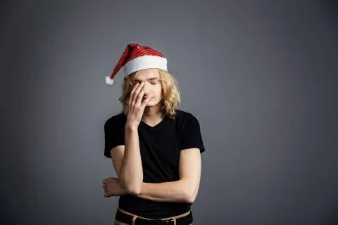 Young guy an attractive guy with long blonde hair in the form of a Christmas  Stock Photos