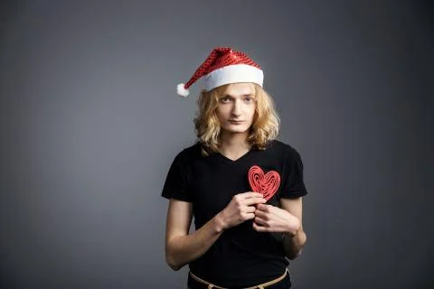 Young guy an attractive guy with long blonde hair in the form of a Christmas  Stock Photos