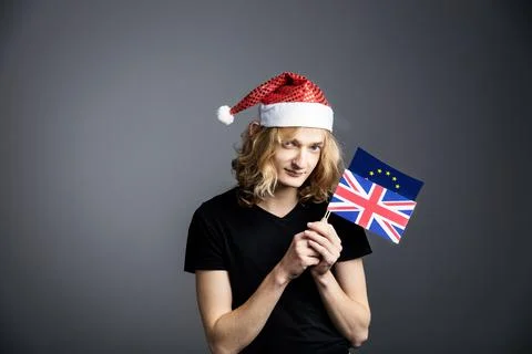 Young guy an attractive guy with long blonde hair in the form of a Christmas  Stock Photos