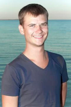 Young guy on the background of the sea Stock Photos