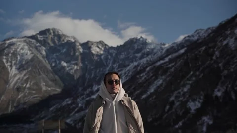 Young guy basking in the sun in the mountains Stock Footage 169811430