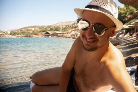 Young guy at the beach looking at the camera Stock Photos