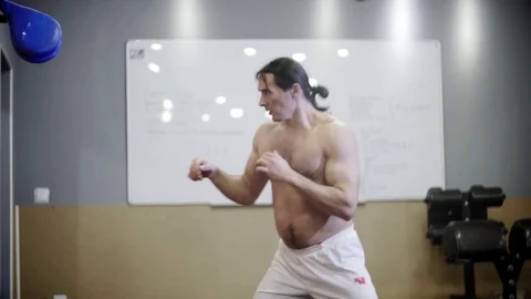 Young guy with a beautiful torso and long hair, trains Video stock 126921958