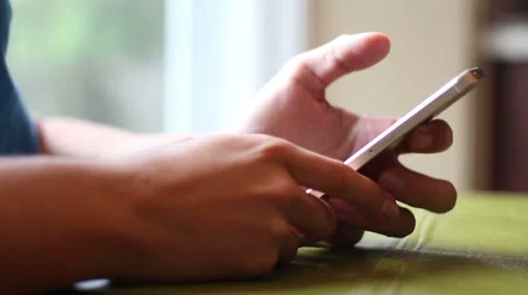 Young guy browsing on his smartphone Stock Footage 62052196