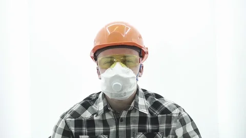 Young guy in a builder costume covers his ears Stock Footage 107008798