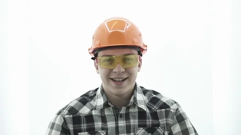 Young guy in builder costume smiling and spinning spinner Stock Footage 107008760
