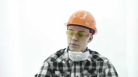 Young guy in a builder costume talking on the phone Stock Footage 107008796