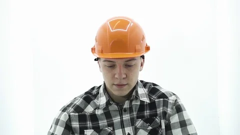 Young guy in a builder costume is wearing safety glasses Stock Footage 107008759