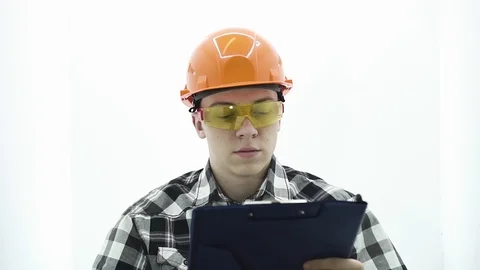 Young guy in a builder costume working on the tablet Stock Footage 107008755