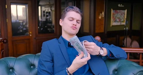 Young guy businessman freelancer counts money. Dollars, income, finance Stock Footage 113102449
