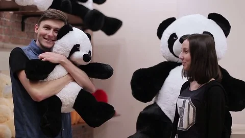 A young guy buys a stuffed toy. Stock-Footage 73714060