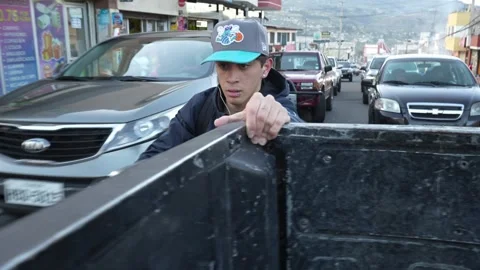 Young guy on bycicle Grabs Onto a Moving Car in traffic in Ecuador.MOV 스톡 동영상 277630679